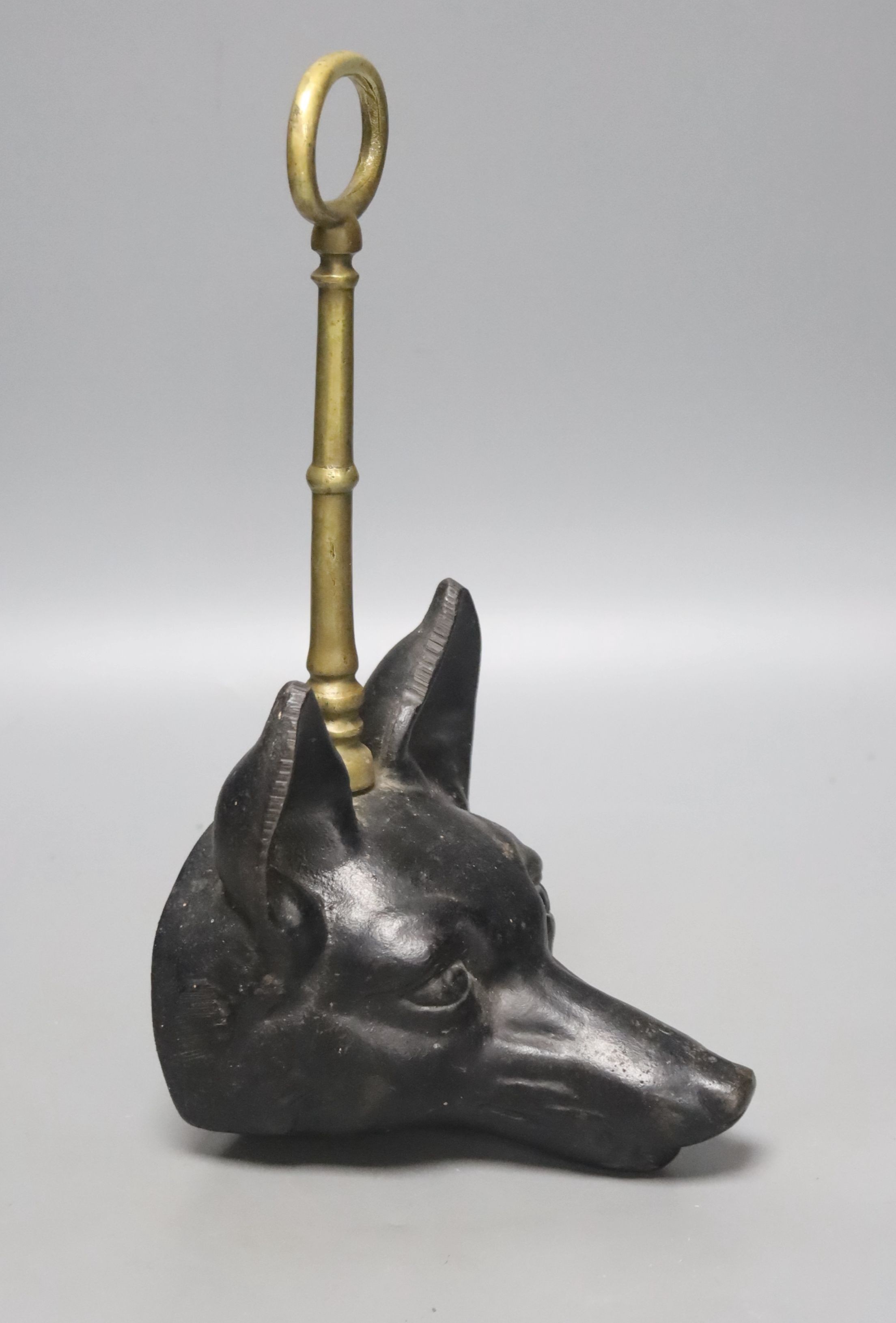 A cast iron and brass foxhead doorstop, 30cm tall